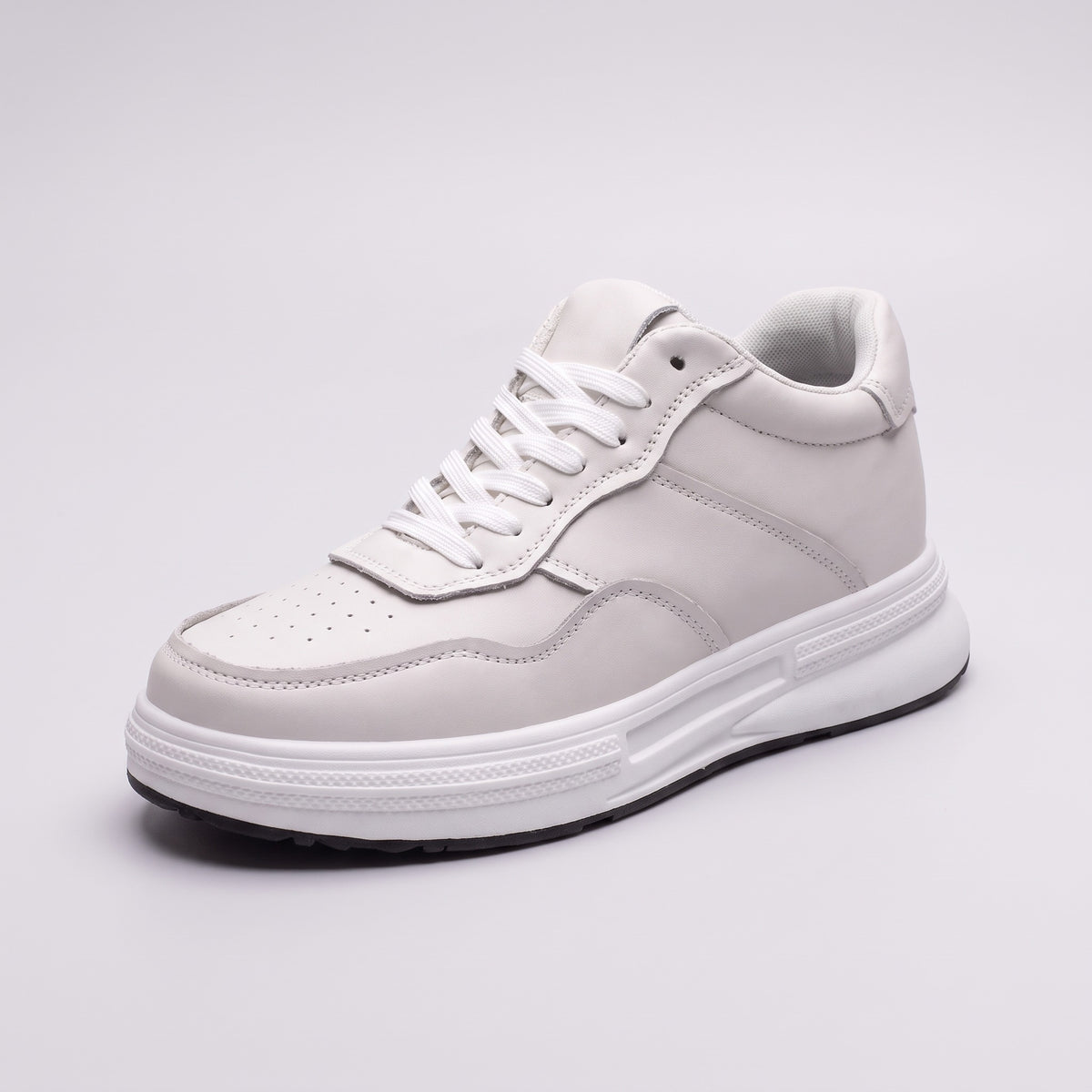 The Crest in white leather, three-quarter view on a pale grey studio background