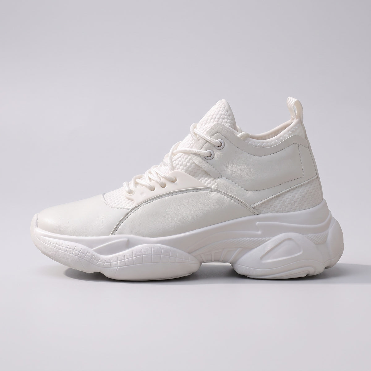 The Ridge chunky trainer in white, side profile on a pale grey studio background