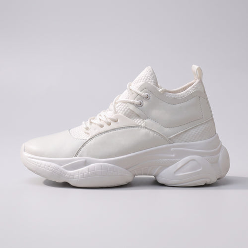 The Ridge chunky trainer in white, side profile on a pale grey studio background